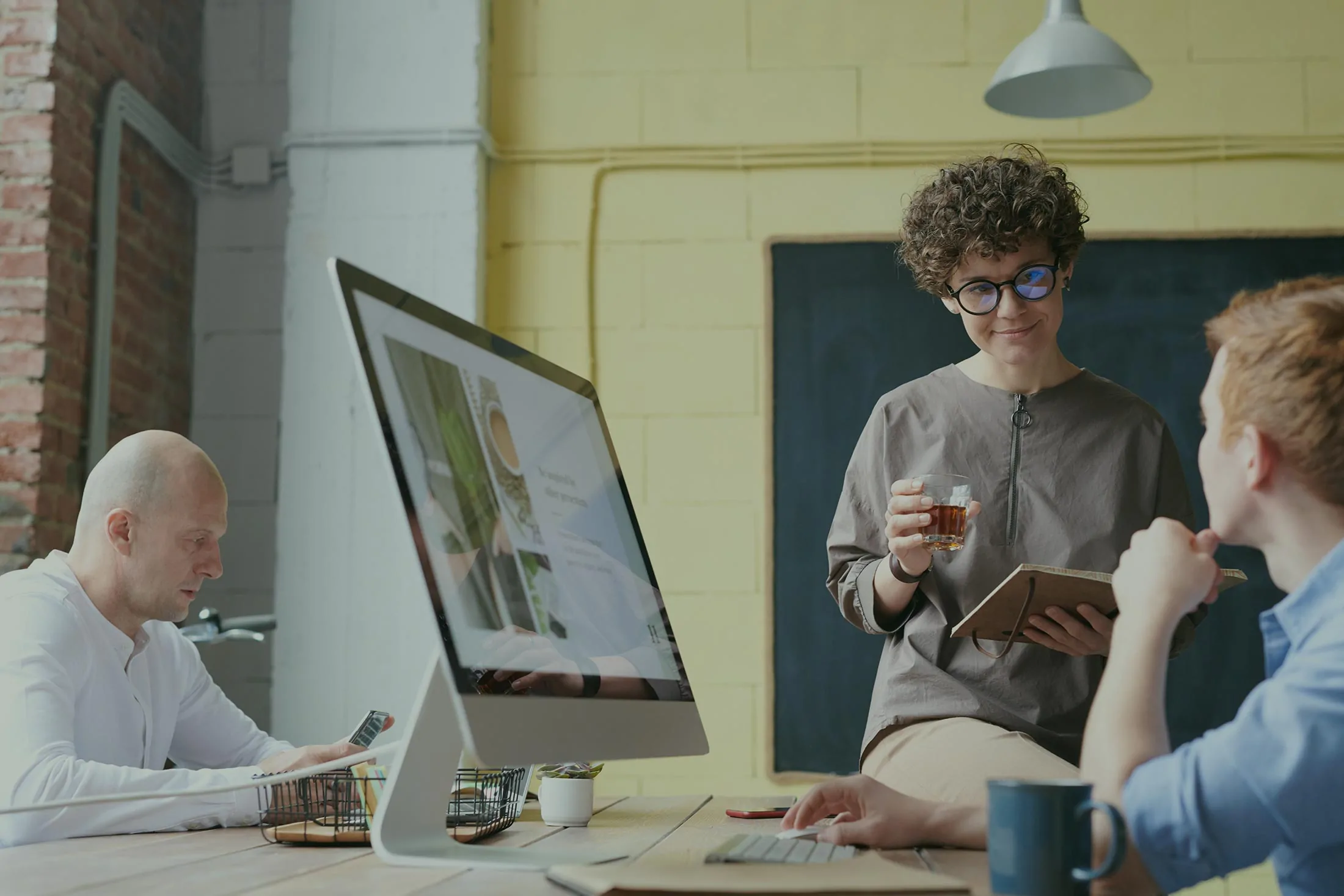 People working at computers in a bright office